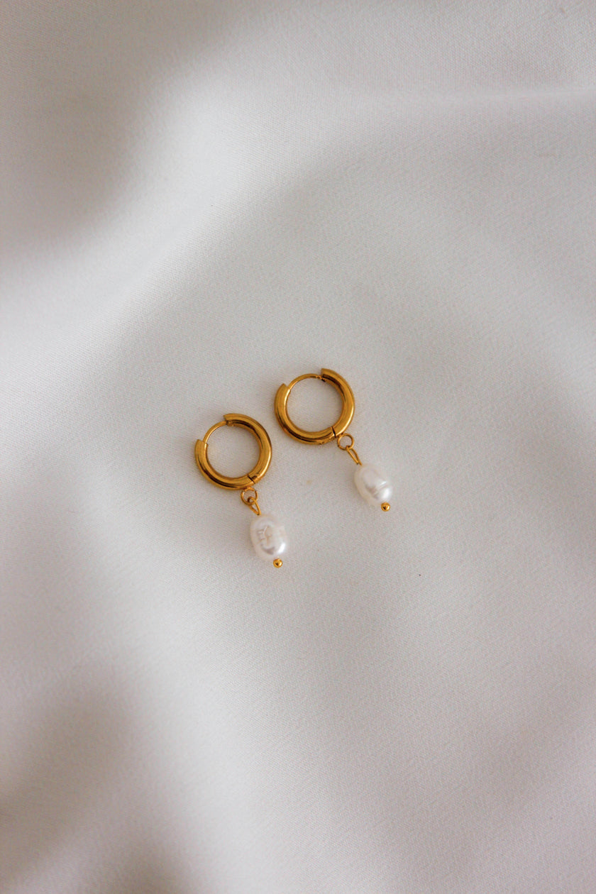 Steel hoop earrings with freshwater pearls.