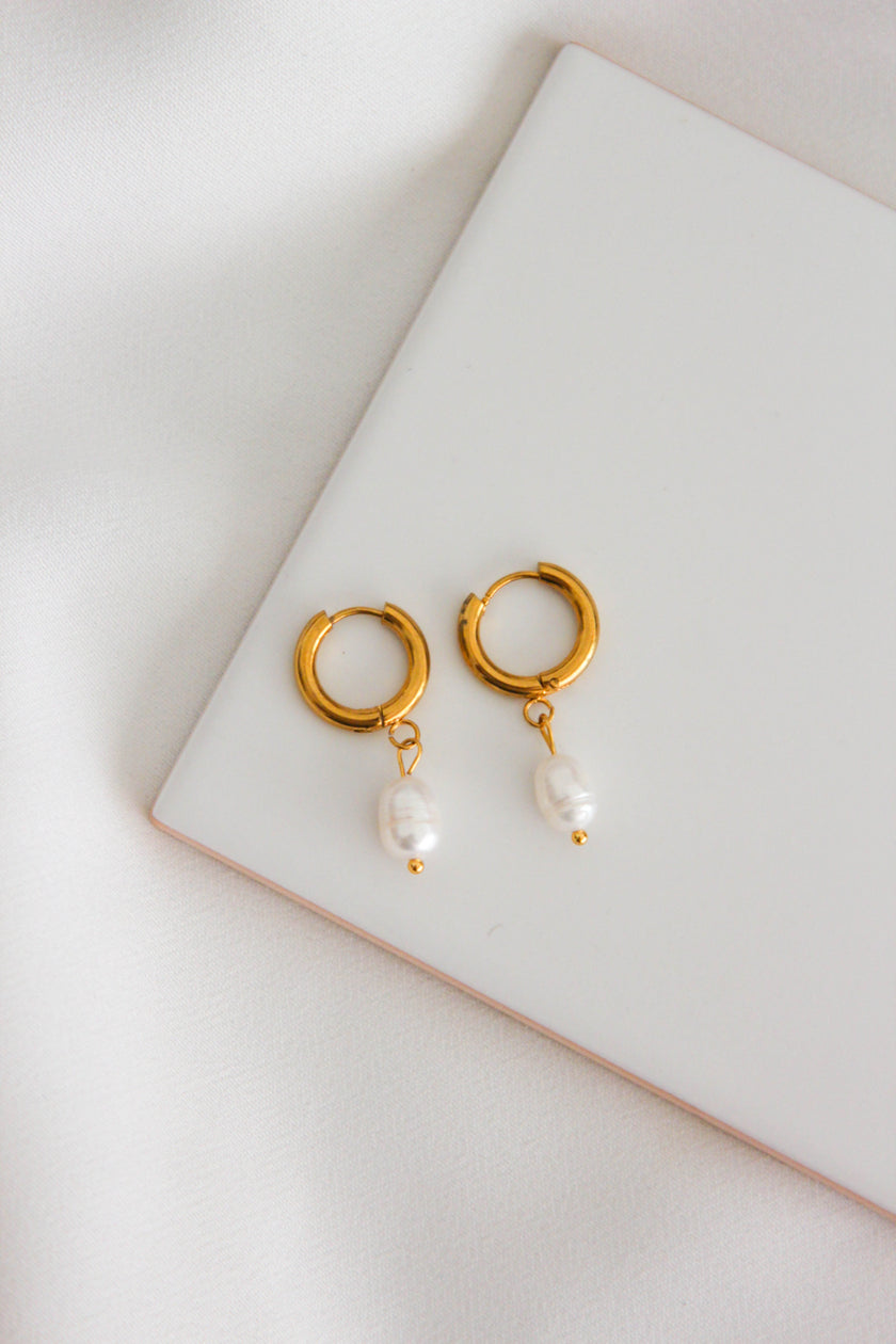 Steel hoop earrings with freshwater pearls.