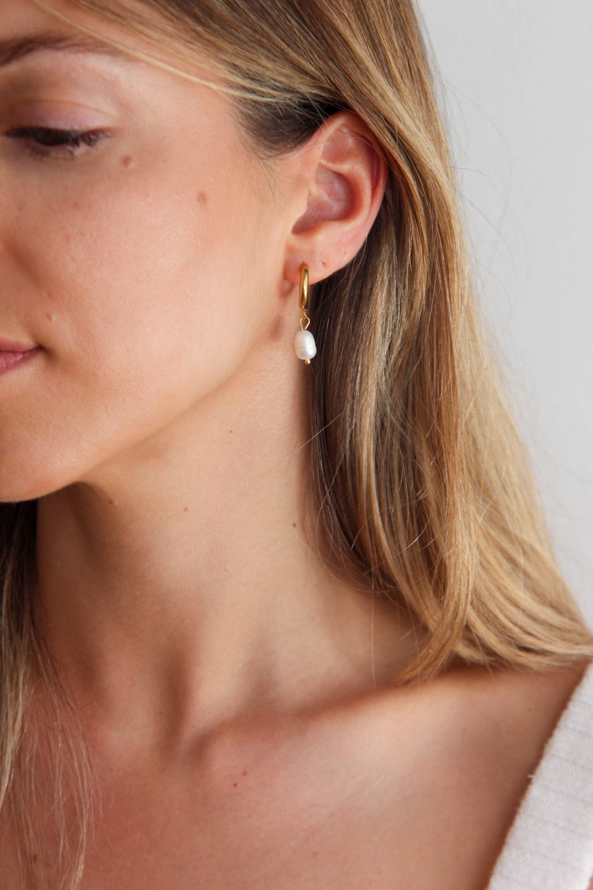 Steel hoop earrings with freshwater pearls.