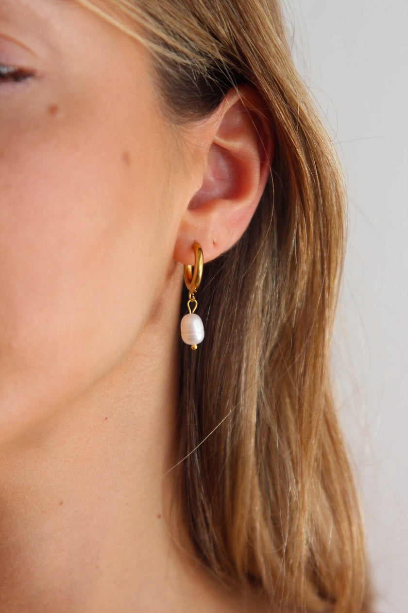 Steel hoop earrings with freshwater pearls.