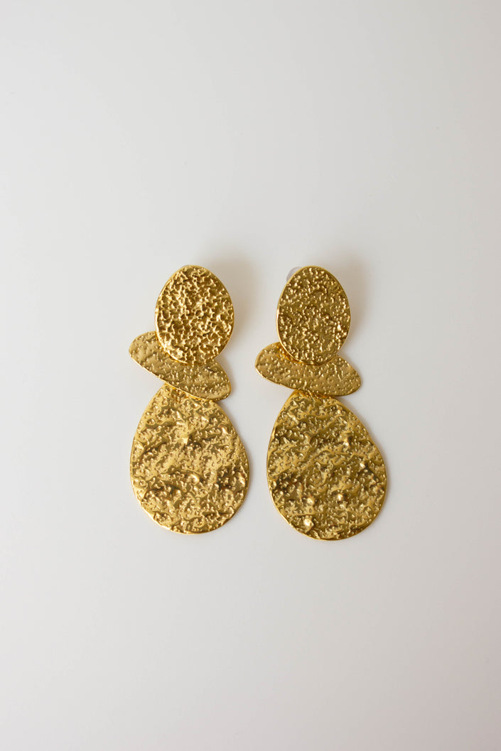 Long, textured, gold-plated steel earrings with geometric design.