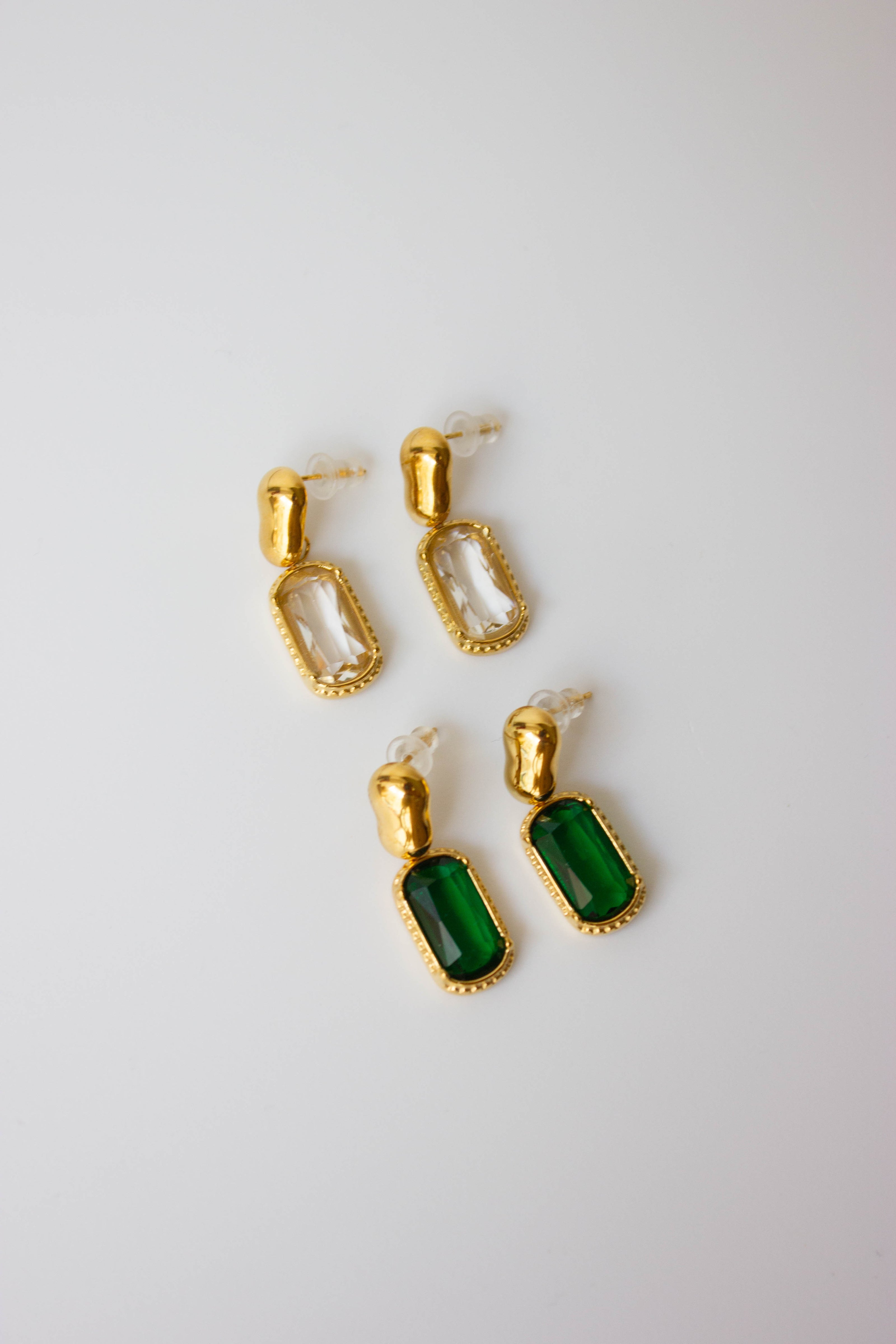 Gold-plated steel earrings with green or clear stone.