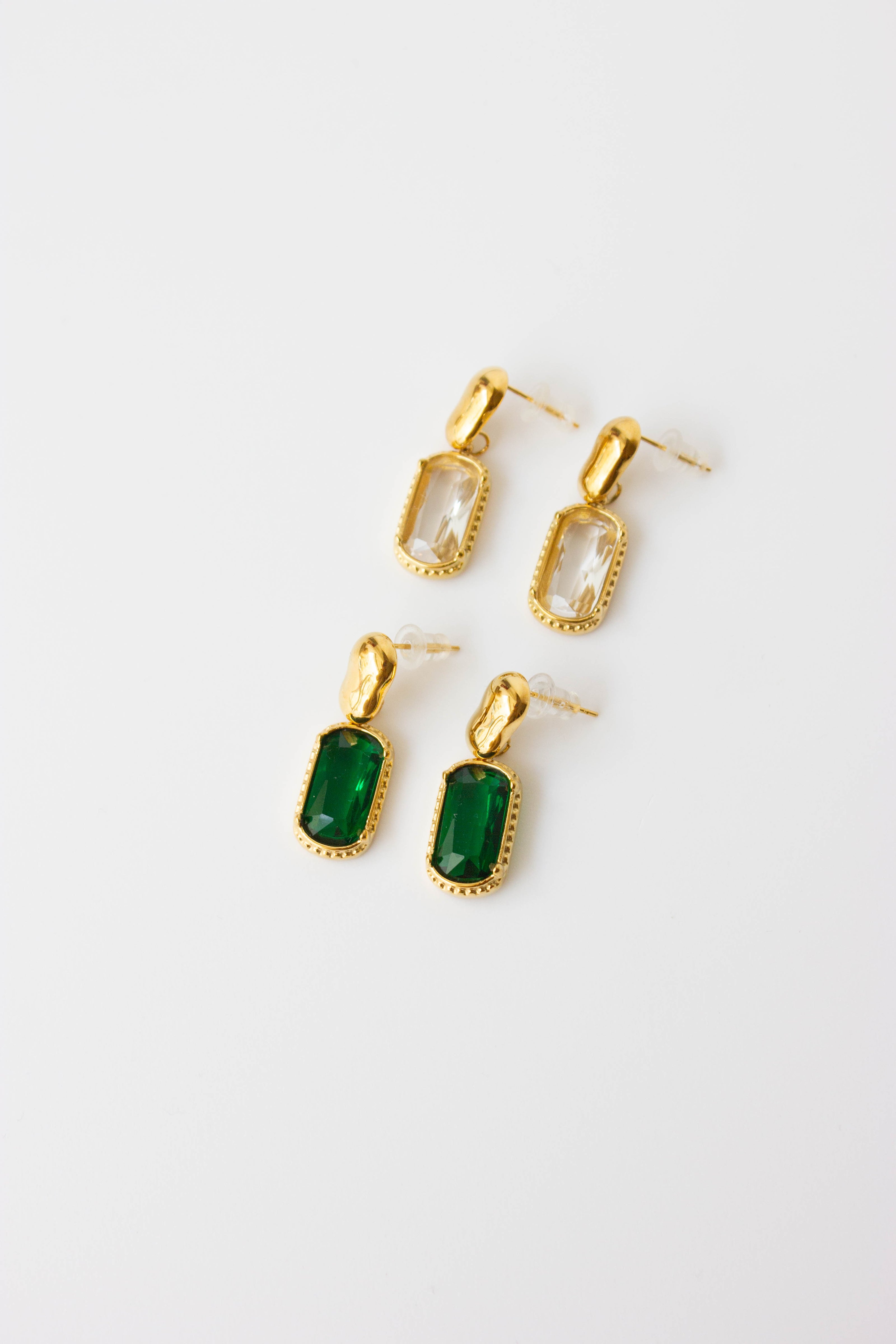 Gold-plated steel earrings with green or clear stone.