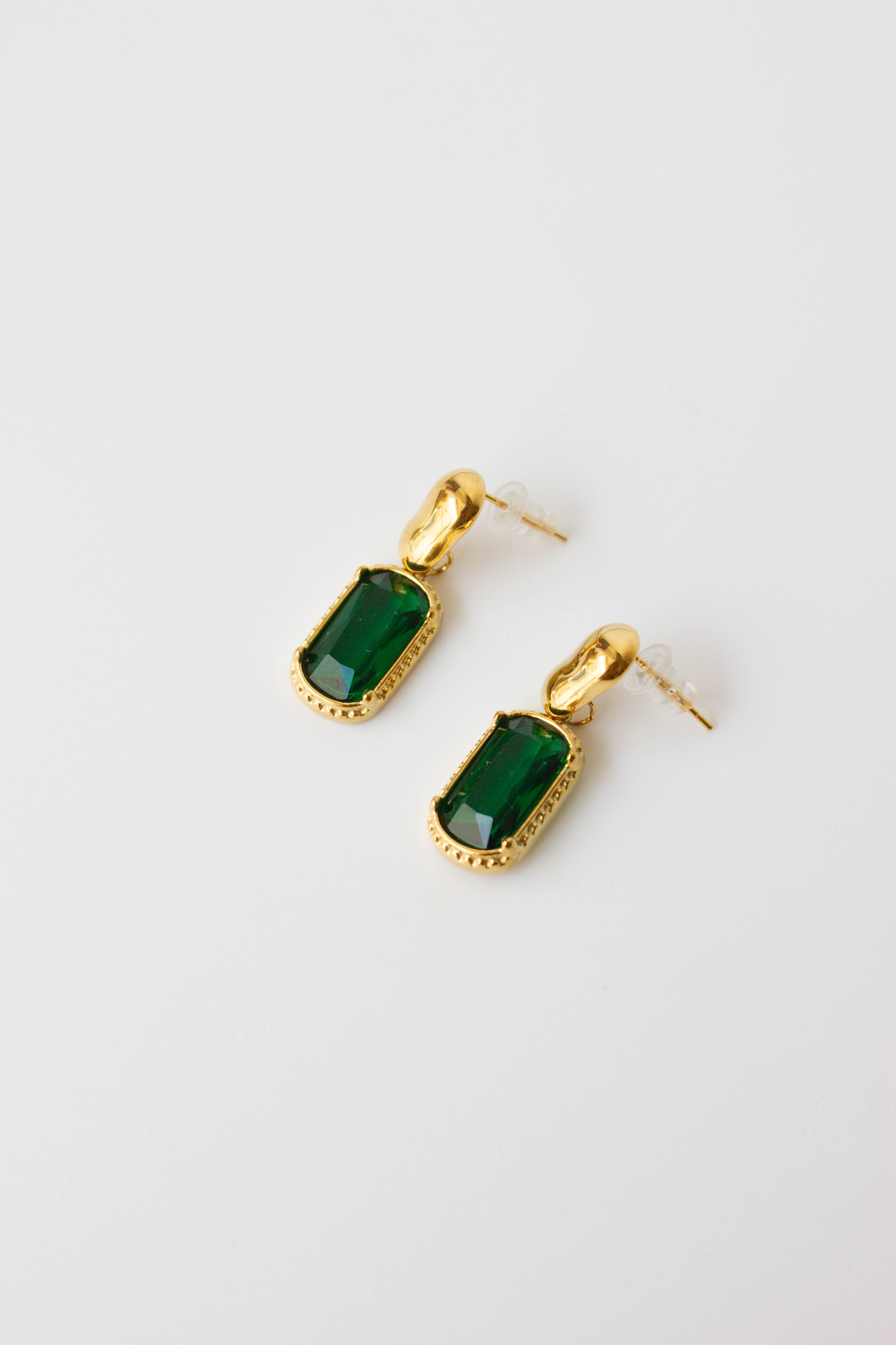 Gold-plated steel earrings with green or clear stone.