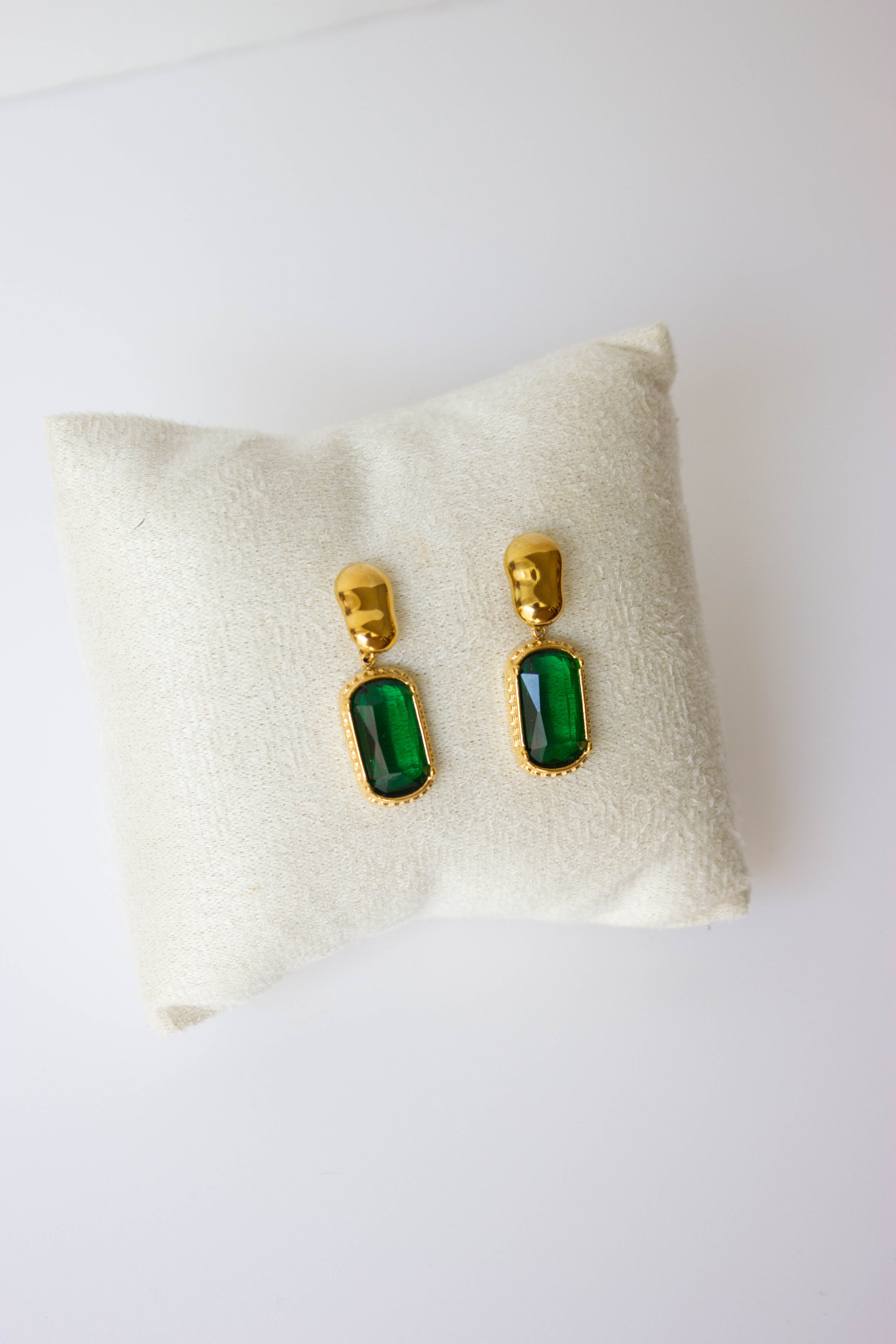 Gold-plated steel earrings with green or clear stone.