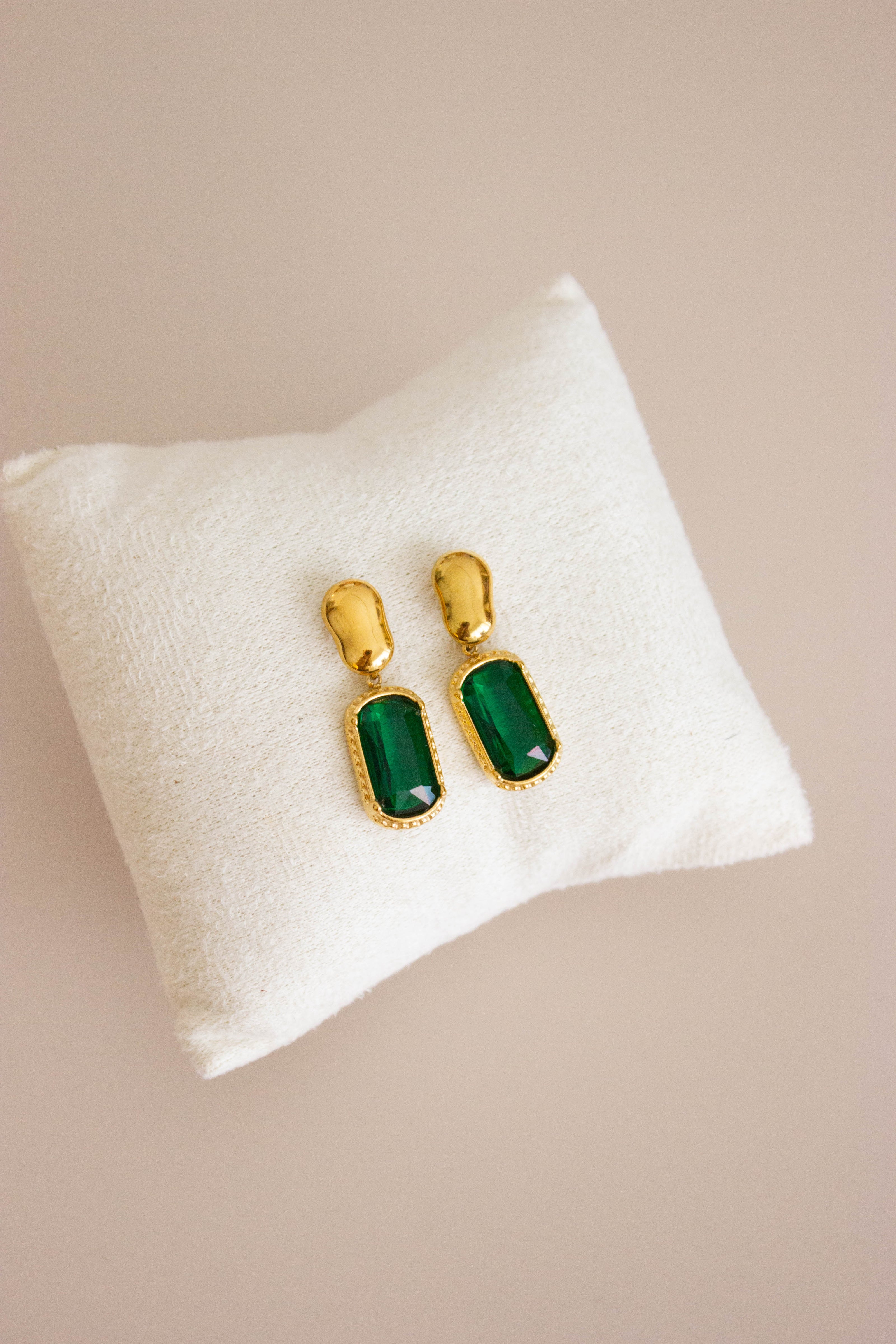 Gold-plated steel earrings with green or clear stone.