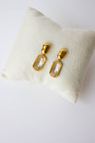 Gold-plated steel earrings with green or clear stone.
