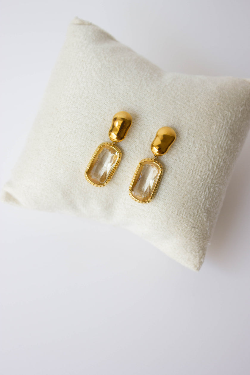 Gold-plated steel earrings with green or clear stone.