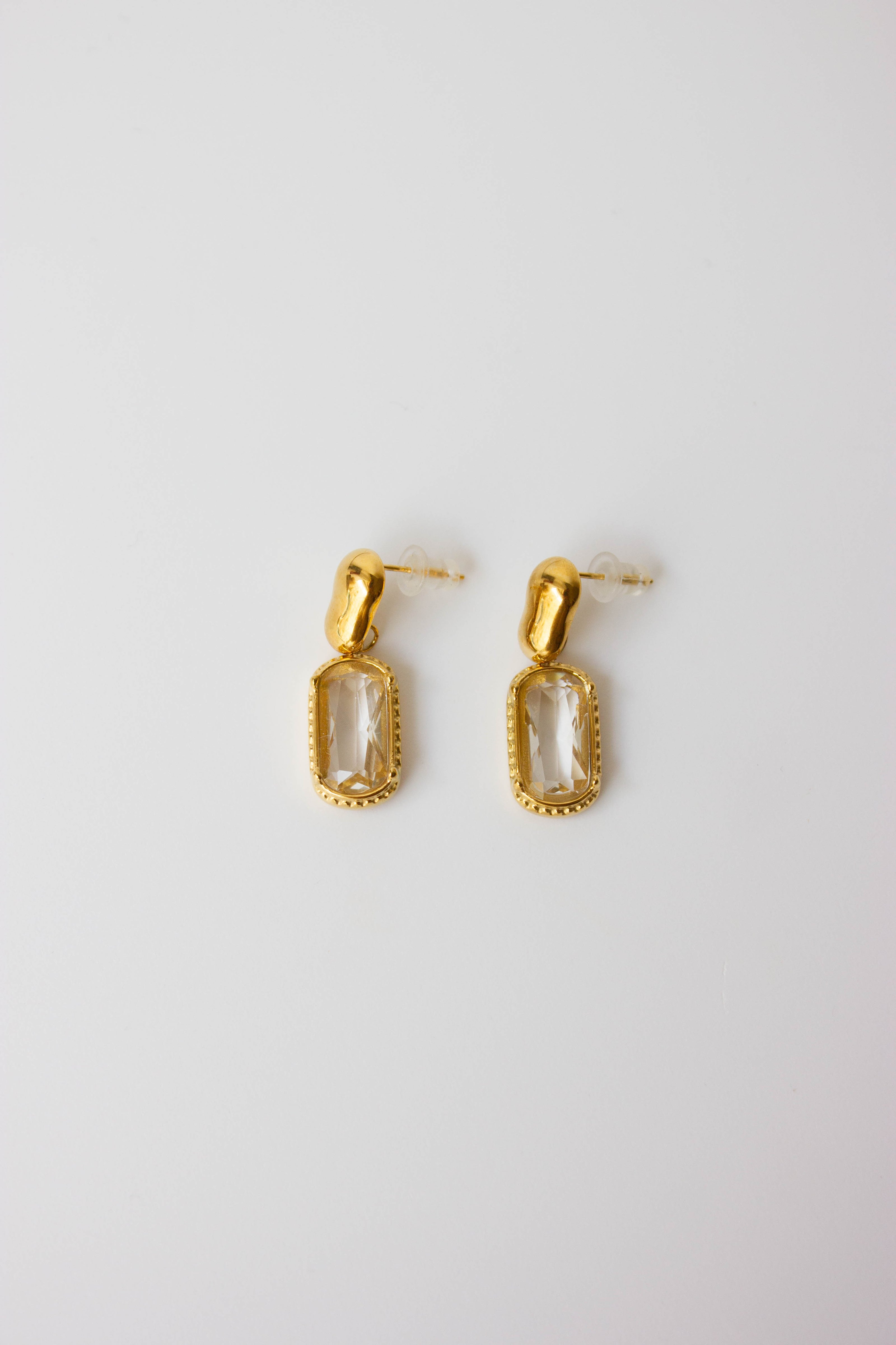Gold-plated steel earrings with green or clear stone.