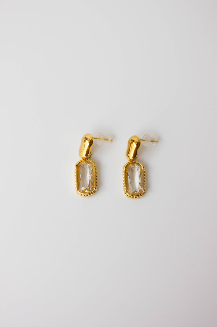 Gold-plated steel earrings with green or clear stone.