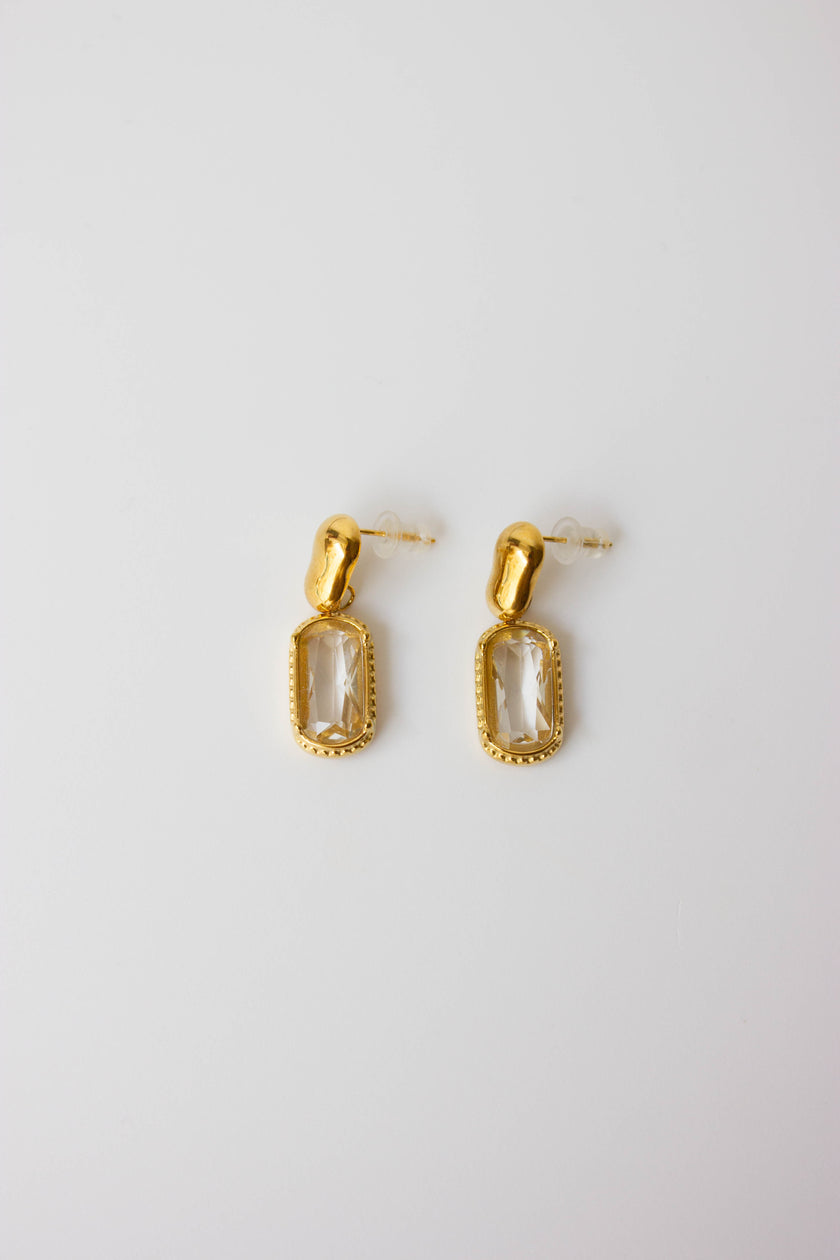 Gold-plated steel earrings with green or clear stone.